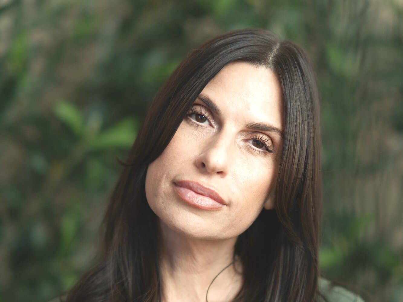 Tonia Padilla, lead aesthetician at éclat Spa & Wellness, in olive scrubs